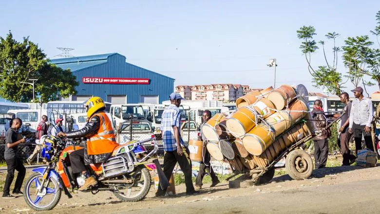 Nairobi, Kenya: Taxi motorcycle and barrels for clean water