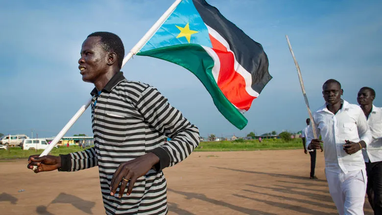 South Sudan: Man holds flag on Independence Day