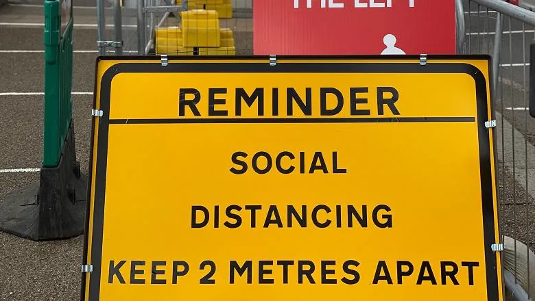 social distancing road sign