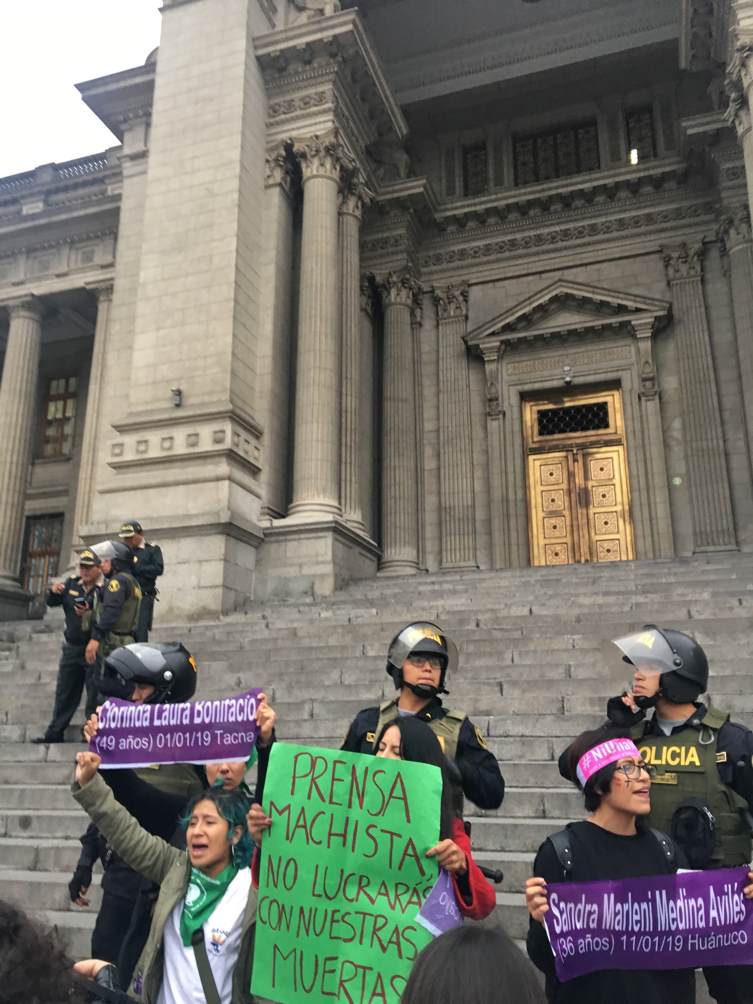 An activist wears a pañuelo verde during an anti-gender violence protest in Lima, June 2019