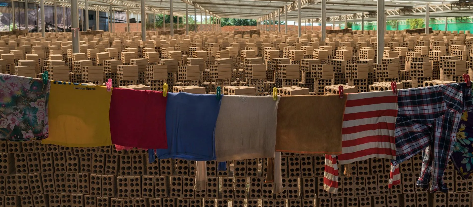 Washing hangs in a Cambodian brick factory