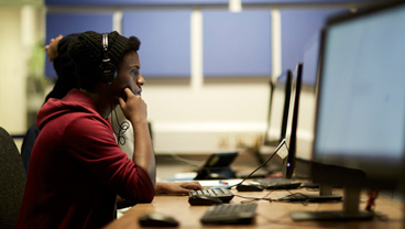 Student working on a library computer at King's College London