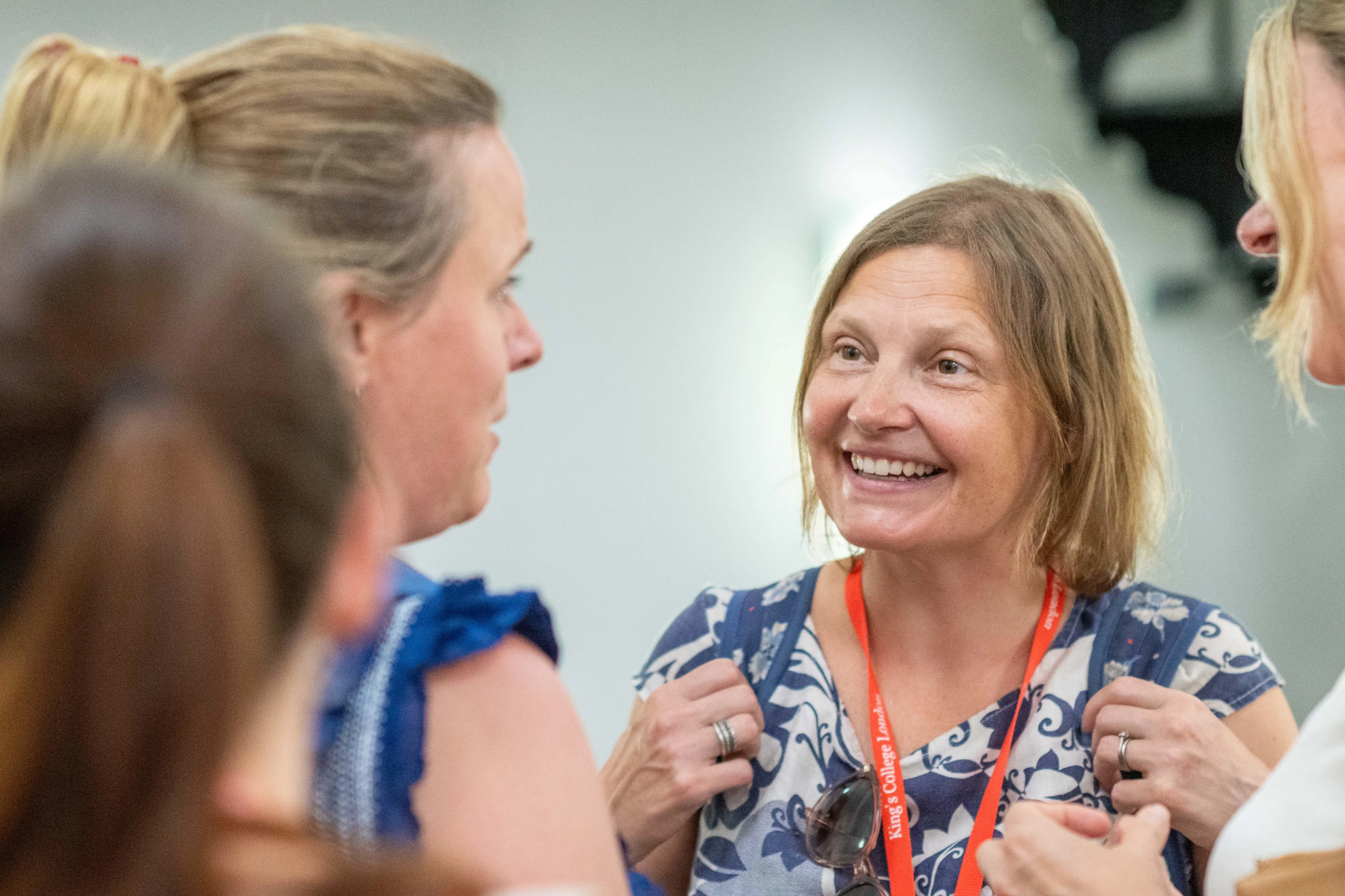 conversation shot with white woman with short brown hair looking engaged and smiling