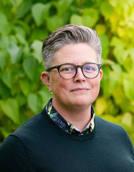 portrait of white woman with short brown and grey hair and glasses