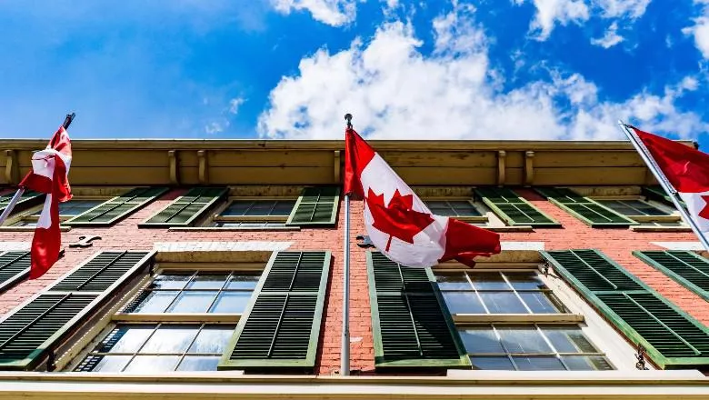 Canadian flag on side of building - by chris robert - 780x440