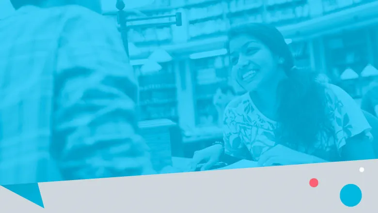 Photo of a woman smiling as she talks to someone, with a blue filter,