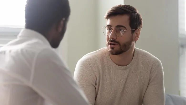 Two men talking intensely
