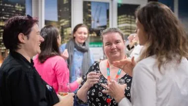 Women talking and laughing at networking event