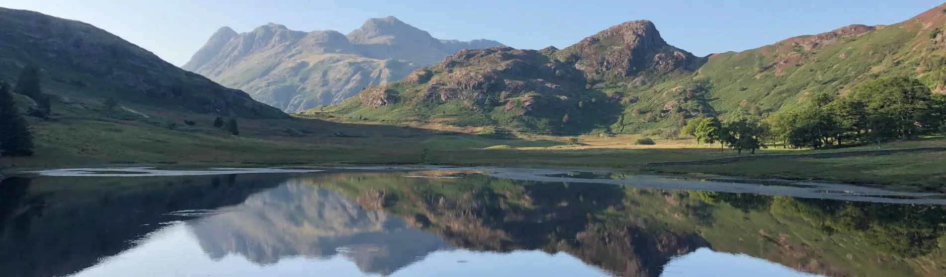 View of the Lake Blea Tarn, with mountains reflected in the water. Credit: Ellie Wood.
