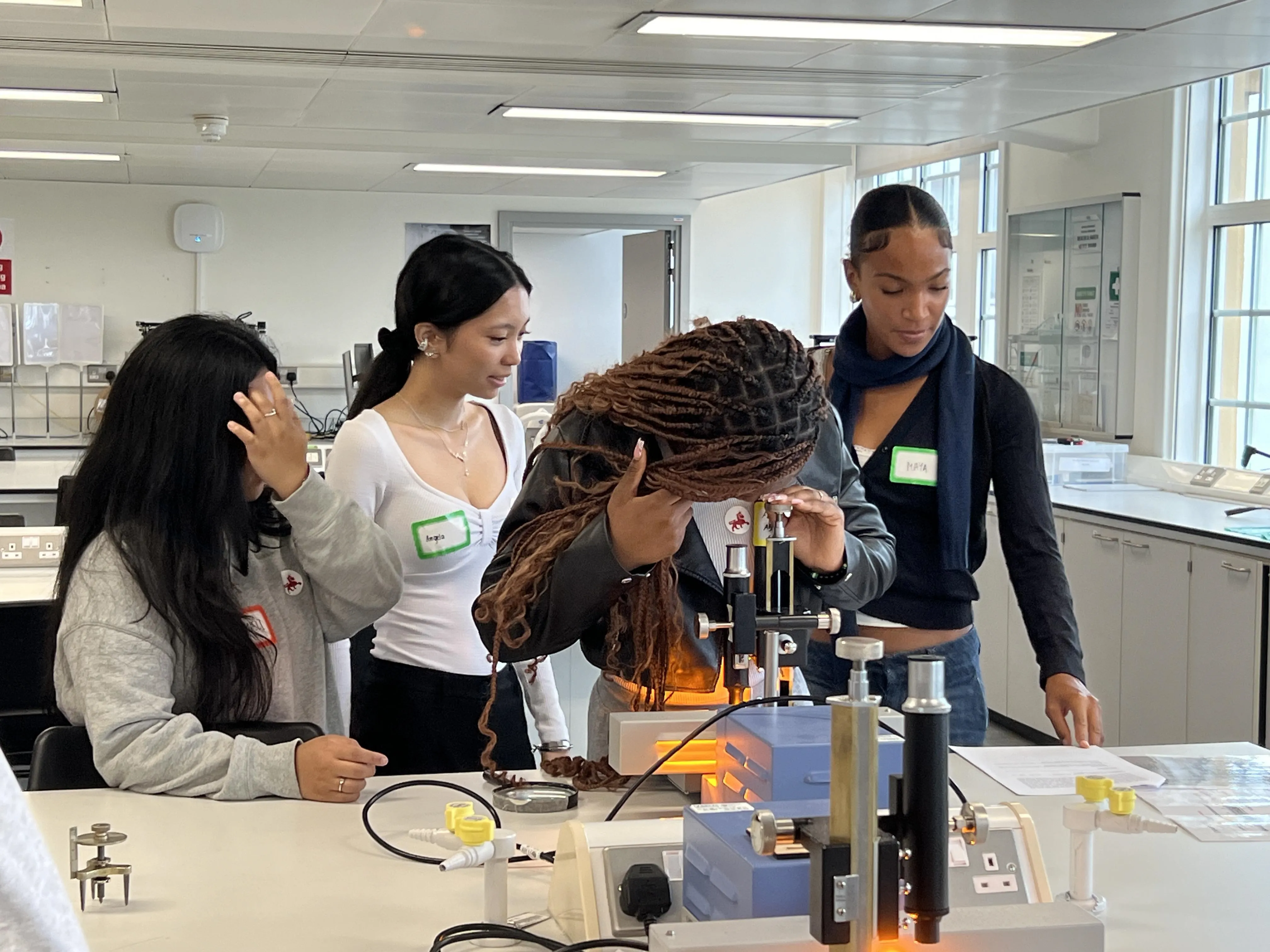 girl looking into a microscope