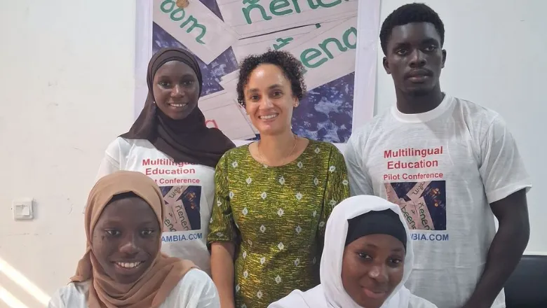five people stood together smiling wearing tshirts that say 'multilingual education pilot conference'