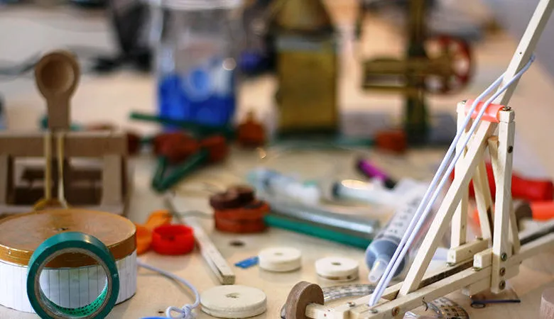 The desk of a science teacher covered with material for experiments