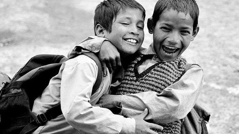 Two Indian boys hugging and smiling