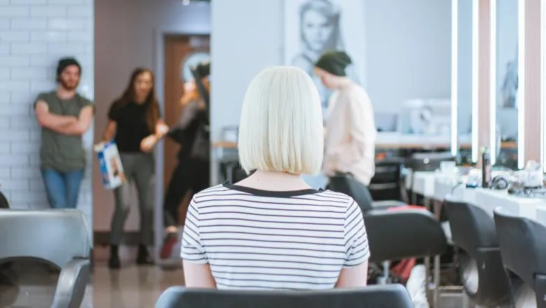 Woman facing into a hair salon