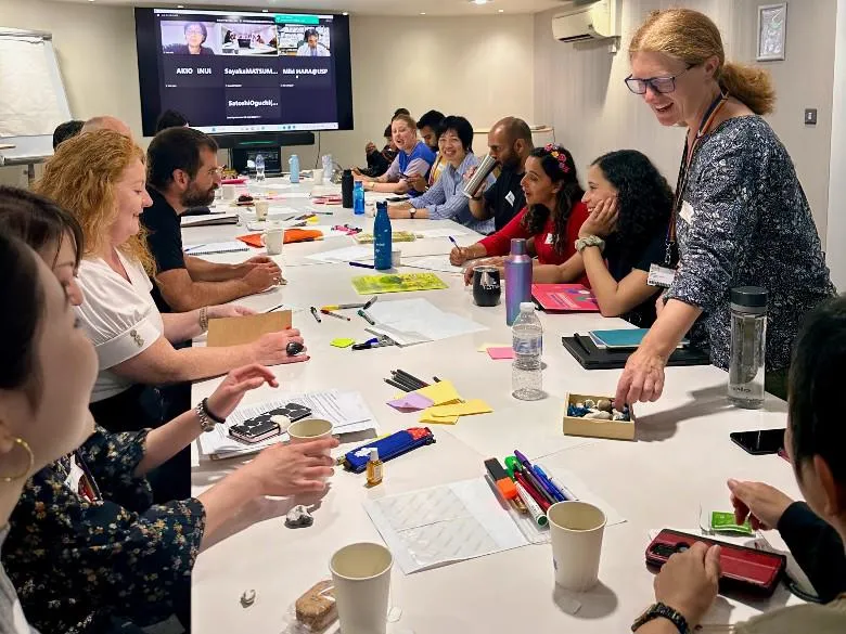 Tania de St Croix explains to the group of UK and Japanese youth workers and researchers a story-sharing activity.