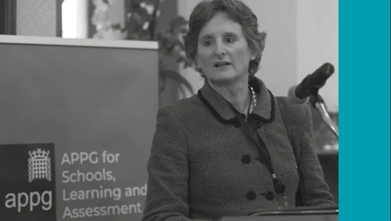 Black and white photo of a woman speaking in a microphone at an APPG event.