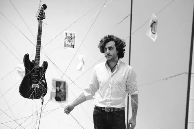 Pablo de Orellana inside the installation “playing” the guitar.