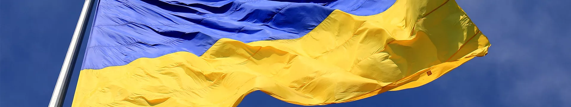 Ukraine flag fluttering against a blue sky