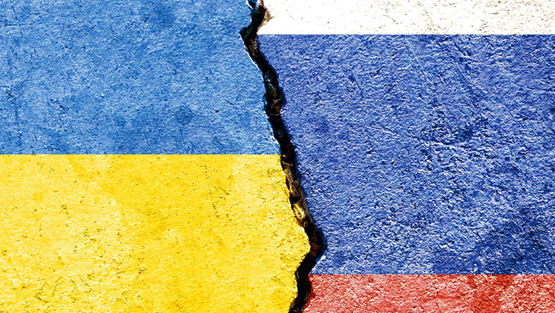 ukraine and russia's flags painted on broken concrete
