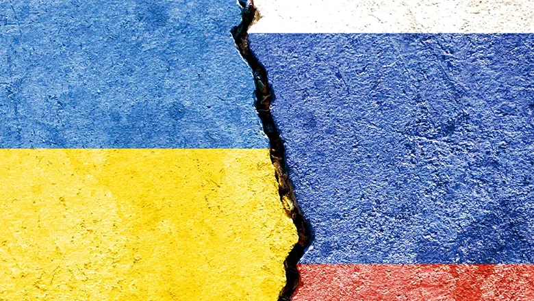 ukraine and russia's flags painted on broken concrete