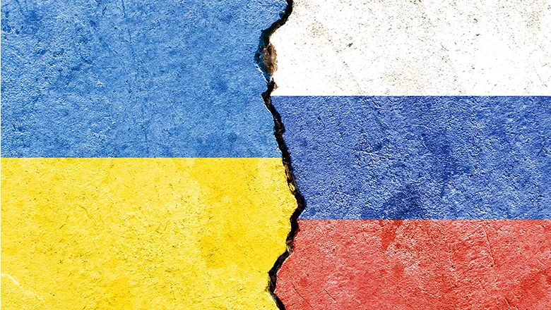 ukraine and russian flag colours painted on broken concrete