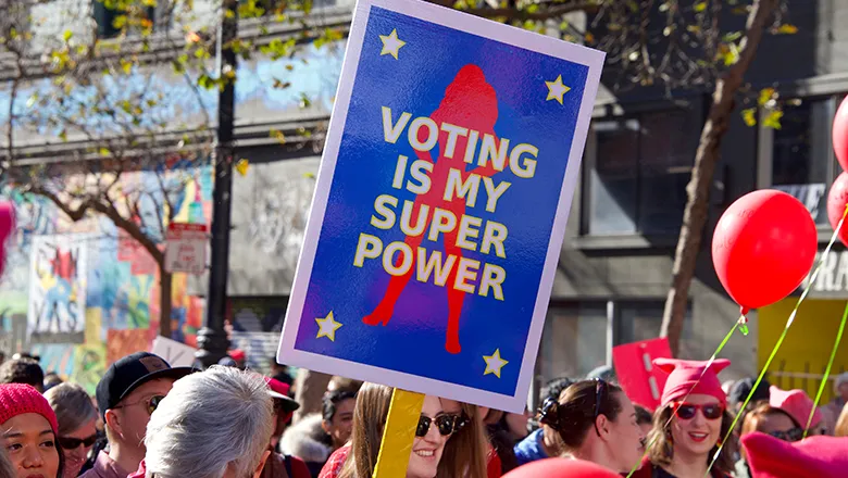 image of women holding a placard saying voting is my super power