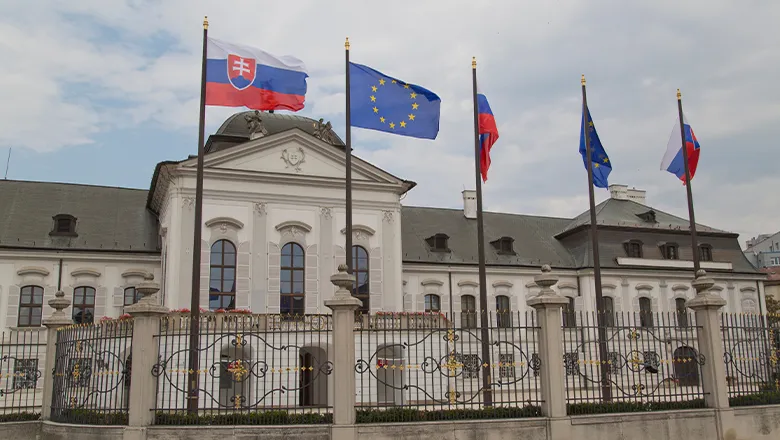 Slovakian and EU flags outside the parliament building in Bratislava