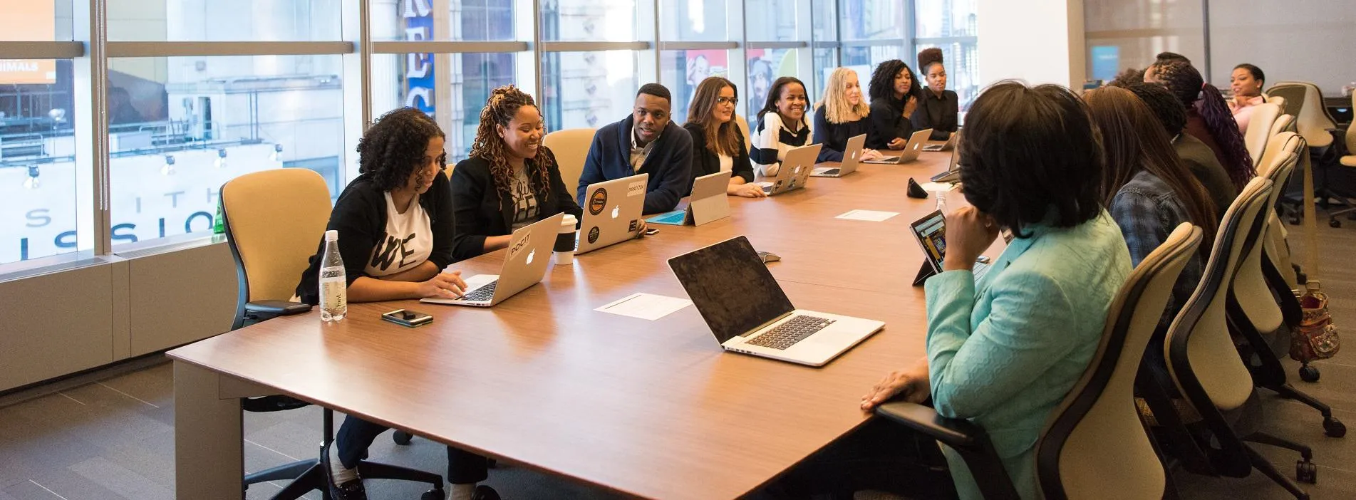 A diverse group of women and men around a boardroom table