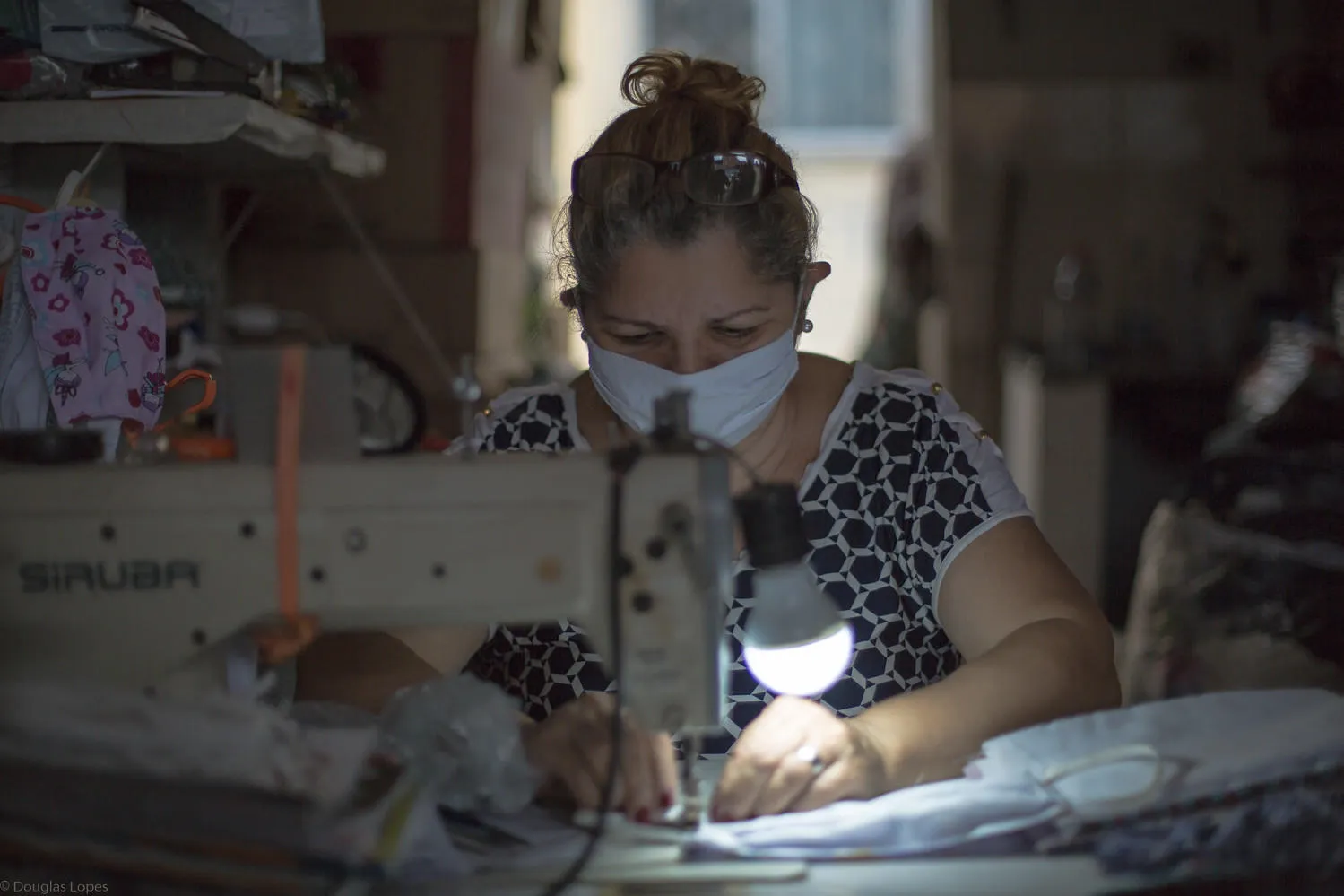 Woman sewing mask in Rio de Janeiro, credit