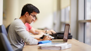 Student working on a laptop, King's College London