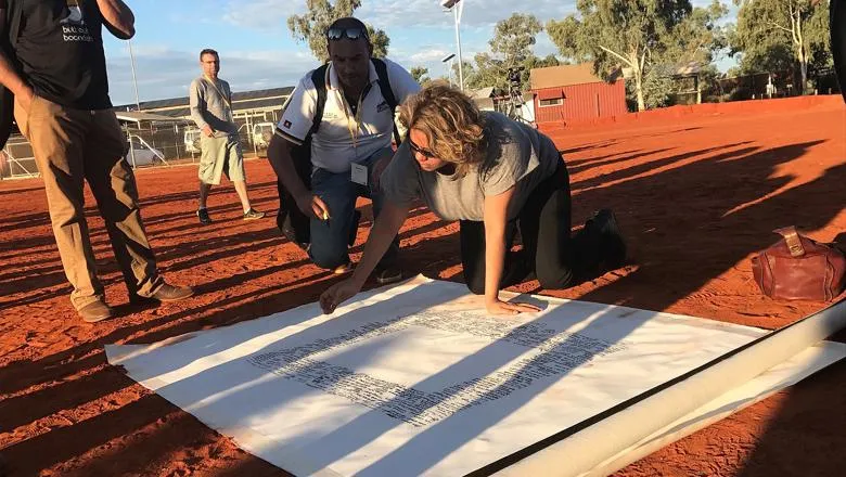 1600px-Denise_Bowden,_Yothu_Yindi_CEO,_signing_the_Uluru_statement