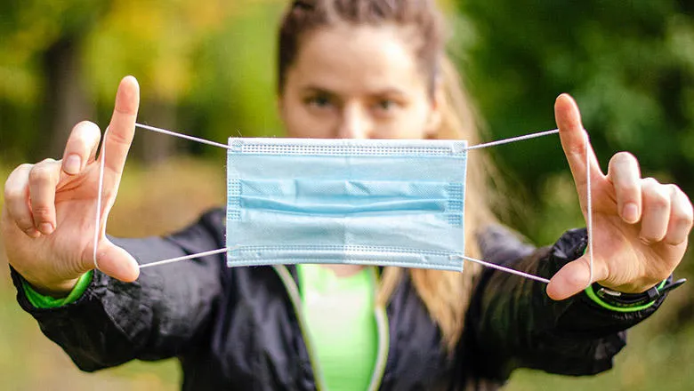 woman stretching face mask