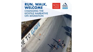 Runners alongside "Welcome to Europe" graffiti