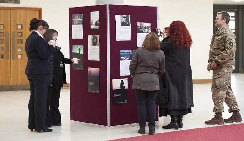 Browsing an exhibition at the Defence Studies Department, for International Women's Day