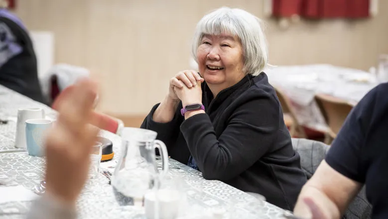 An older person wearing a fitness tracking wristwatch