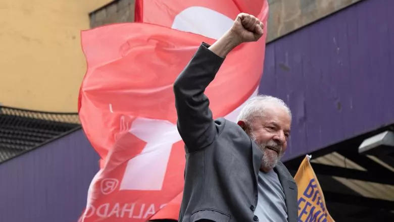 Presidential candidate Luiz Inacio Lula da Silva with his fist in the air and flags behind him on Augusta Street at São Paulo on the eve of the election in October 2022.