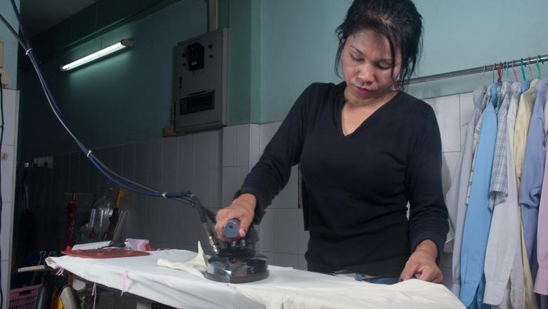 Domestic worker house maid ironing clothes