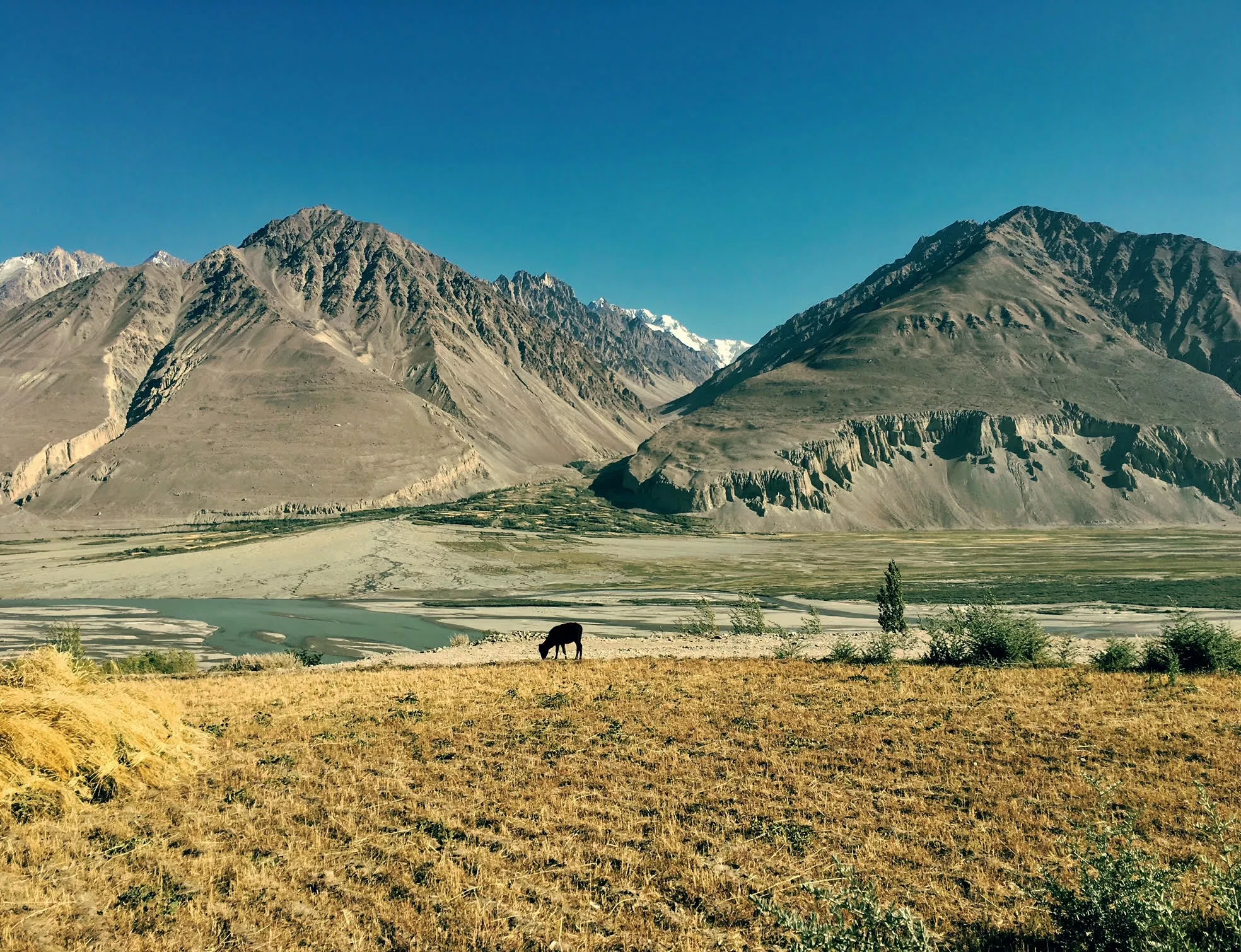 'The Wakhan Valley (among the Afghan counterpart, the Wakhan Corridor) is undoubtedly one of the most remote places that I have been to and that I am aware of. Situated along the Panj river on a detour from the historically famous Pamir Highway, the Tuggoz village (where this picture was taken) lies about 700km away from the nearest cities with considerable facilities (Dushanbe and Osh), in either direction of travel no less than a 3-day drive. The remoteness of the village (with its stunning views of the Afghan Wakhan mountains) is a true questioning on the meaning of globalisation.' – Rubian Renz Dalpian