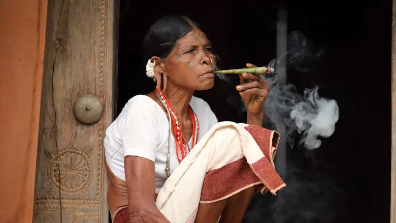Unidentified Sora tribal woman in a rural village near Gunupur in Odisha, India. The Sora tribe is famous for the tattooed faces and big earrings.