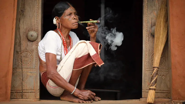 Unidentified Sora tribal woman in a rural village near Gunupur in Odisha, India. The Sora tribe is famous for the tattooed faces and big earrings.