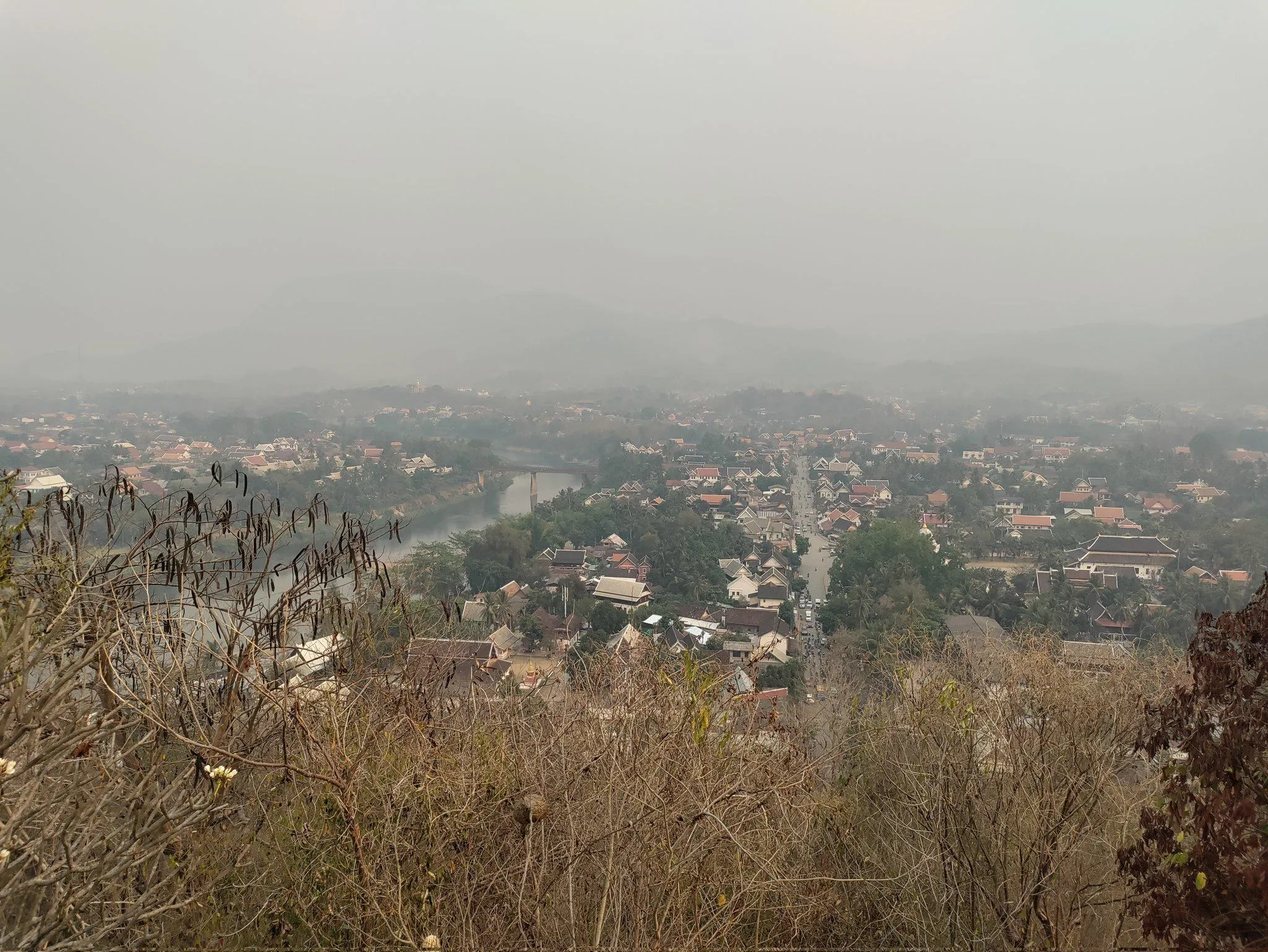 Tracking air pollution in Laos during fire season in March 2023. View of a settlement in Laos enveloped in smoke from wildfires