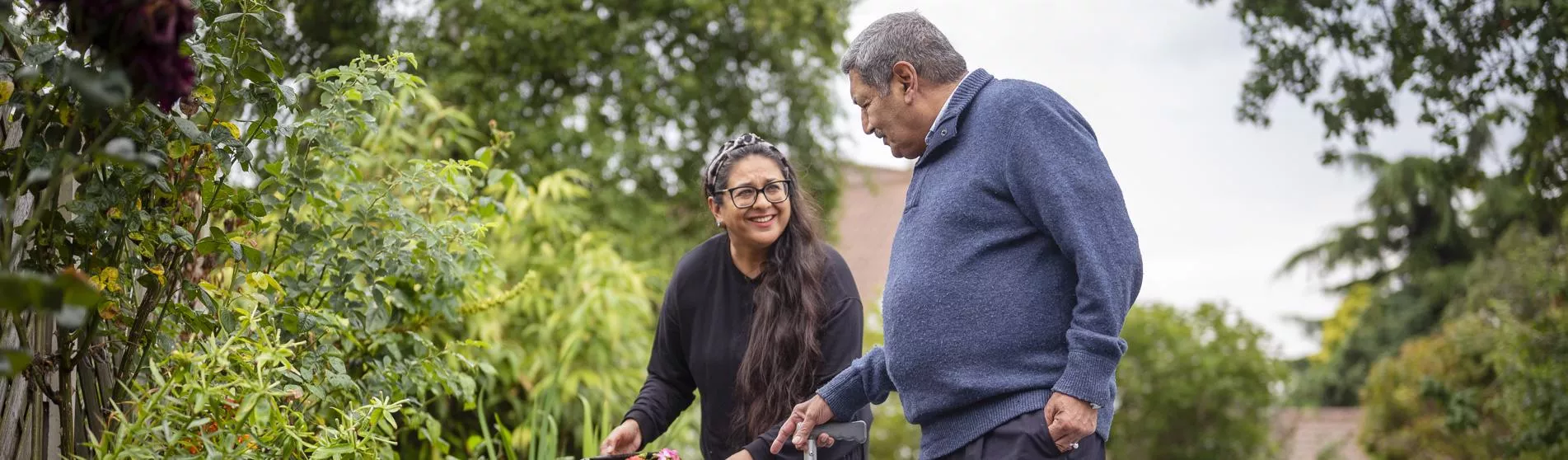 Women helping older man in garden - Touchstone’s Sikh Elders Service Leeds