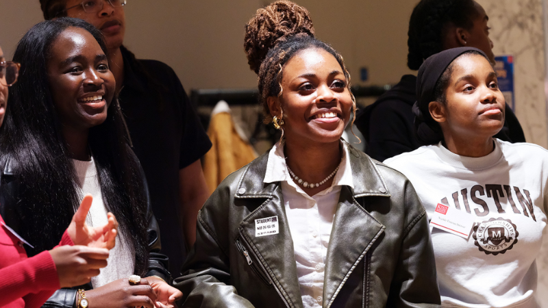 Three students smiling
