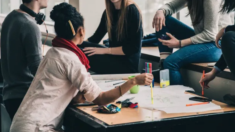 Students working around a table