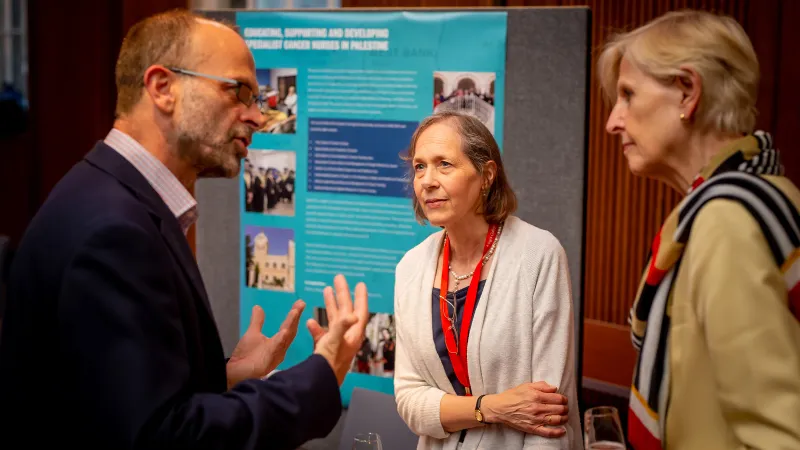 A group of people at a stall for a nursing research project