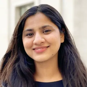 Amna smiling at the camera in Bush House courtyard