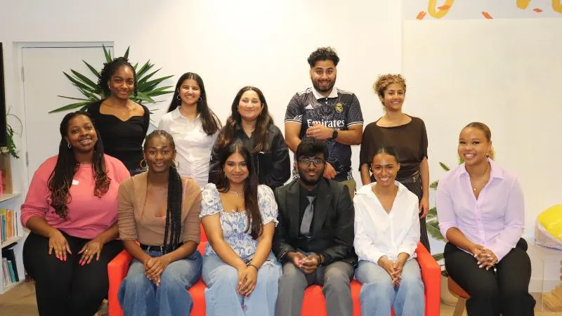 A group of people sitting in two rows and posing for a photograph.