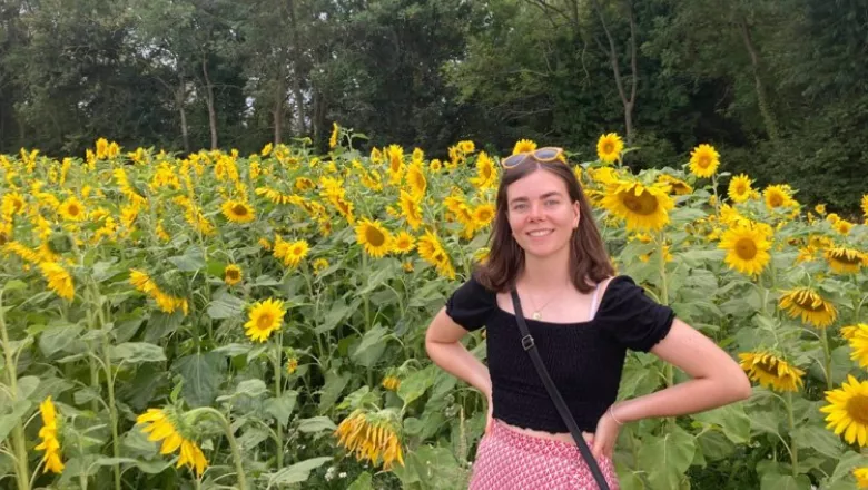 Photo of Laura Walmsley in a field of sunflowers