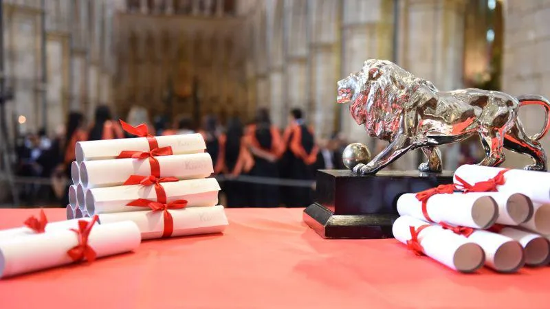 Image of graduation letters at the front of the ceremony