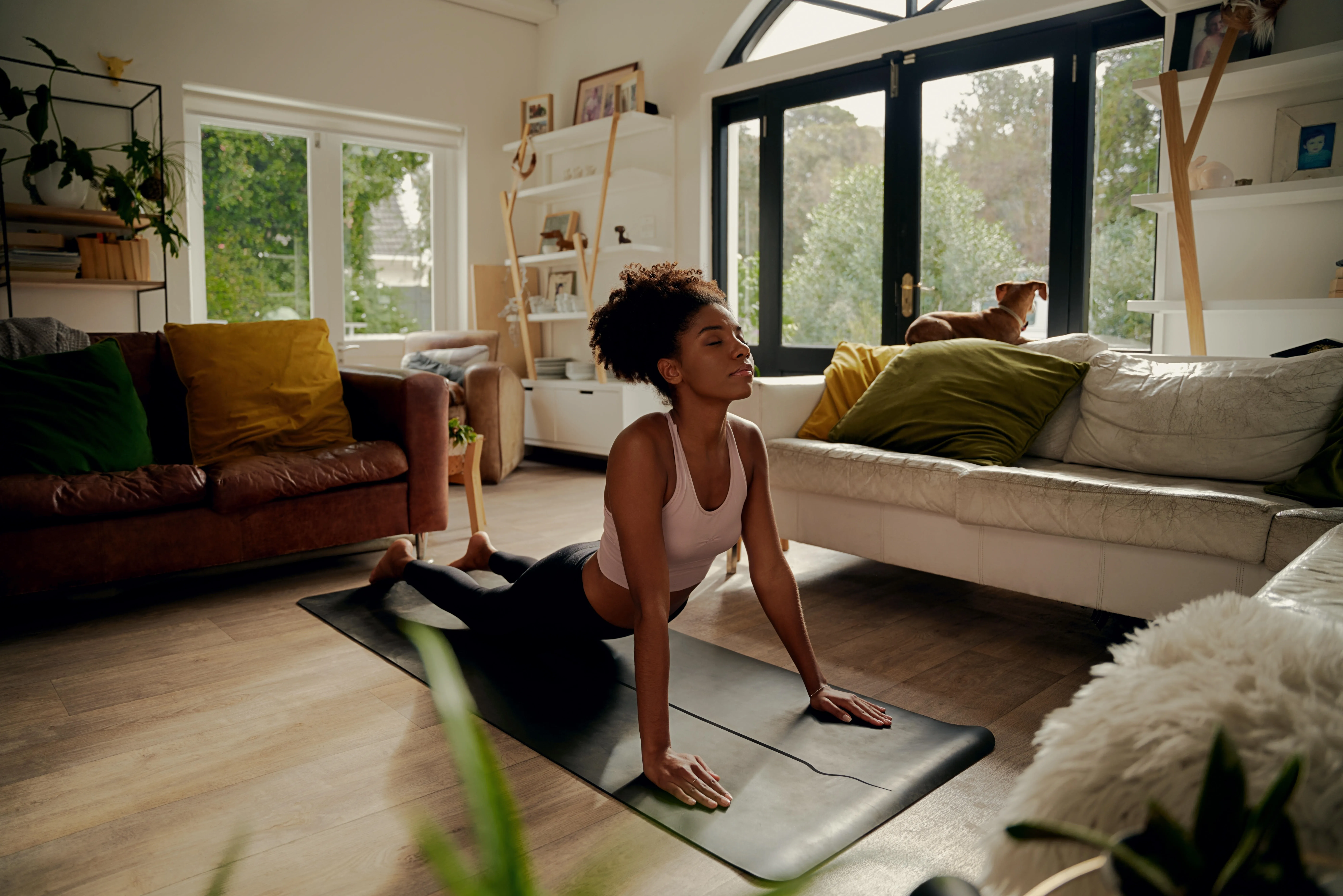 A woman participating in yoga at home